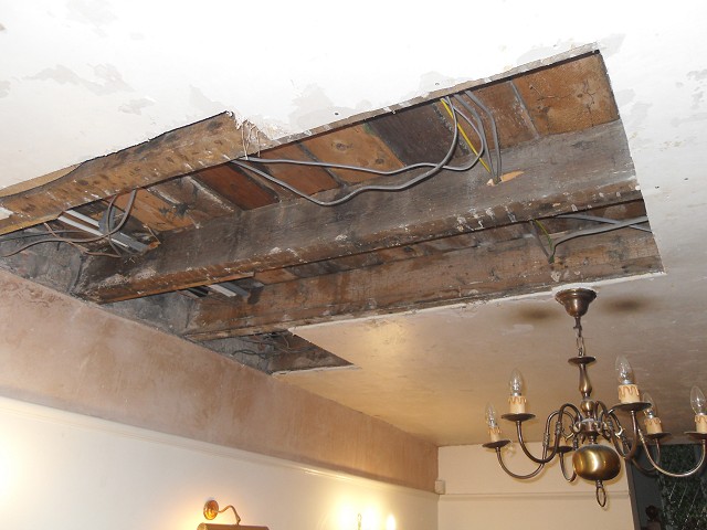 The hole in the ceiling after damaged plaster removal and clean-up.