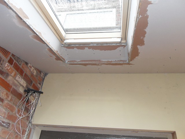 Plasterboard ceiling built-up around joists and Velux.
