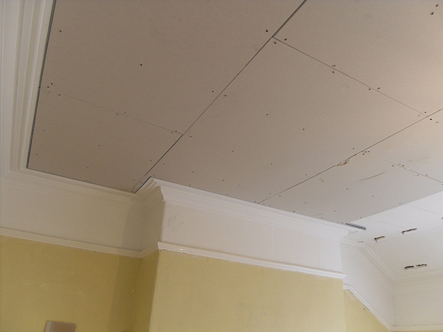 Overboarding of ceiling to protect sensitive corniche